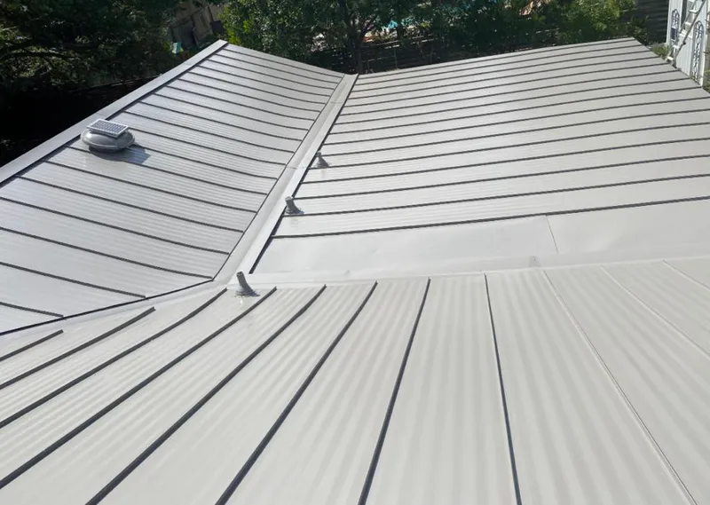 Solar attic fan installed on a metal roof for Roof Ventilation in Chanute